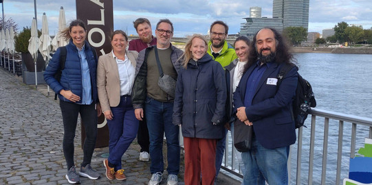 Die Projektpartner von PRAESCO stehen auf einer Brücke auf dem Rhein.